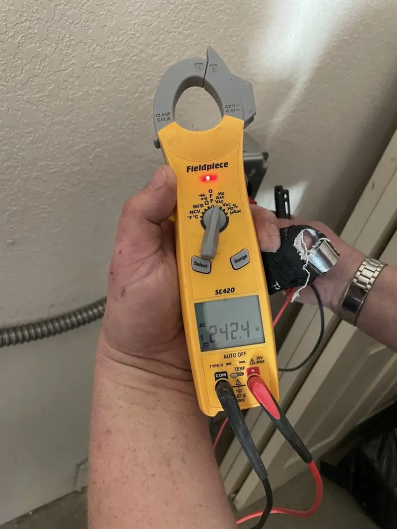 Voltage testing with clamp meter during Electrical Installation Services in Brent